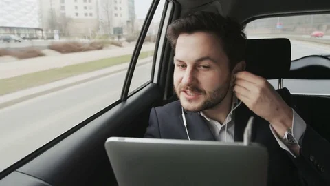 Man in the Car Putting Headphone On and Smiling Stock Footage 74760217