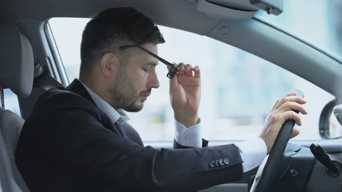 Man in car suffering from vision problems putting glasses on and off, eyesight 動画素材 119286244