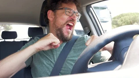 Man in car waiting for traffic to pass to enter lane slow motion Stock Footage 79733674