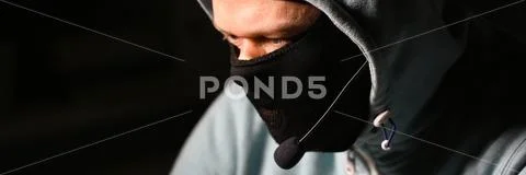Man carder in mask connect to darknet Stock Photos