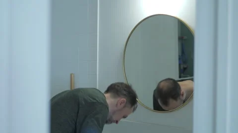 A man carefully brushes his teeth Stock Footage 312063638