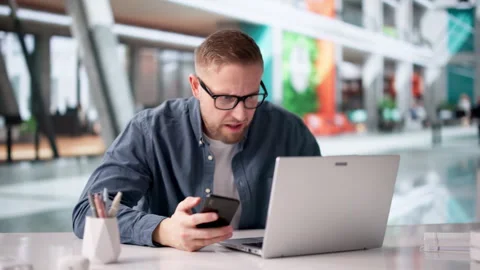 Man Carefully Checks Smartphone For Payment Issues Stock Footage 330582032