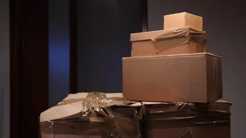 Man carefully lifting moving boxes preparing for relocation Video stock 318981711