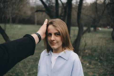 A man caresses the face of his beloved outside. Stock Photos