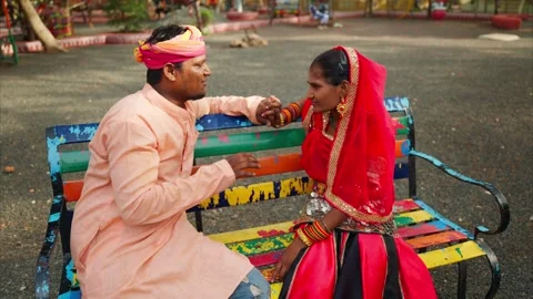 Man caresses woman face while sitting at park side Stock Footage 302073745