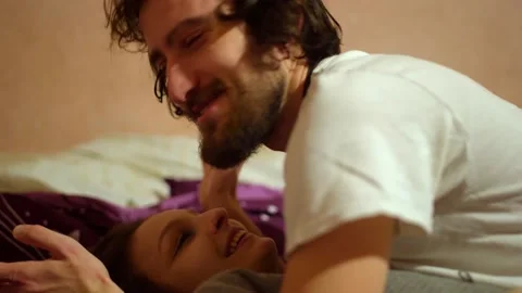 Man Caressing Girlfriend Talking Lovers Couple on Top of Each Other Spooning  動画素材 145842528
