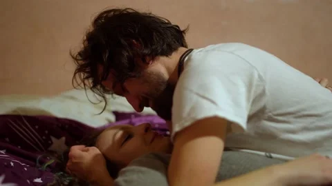 Man Caressing Girlfriend Talking Lovers Couple on Top of Each Other Spooning  Stock Footage 145842549