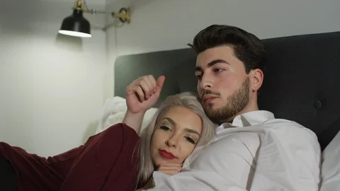 Man caressing a woman's head as they lay together Stock Footage 99941528