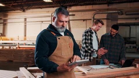 Man, carpenter and design with tablet in warehouse for wood production or Stock Photos