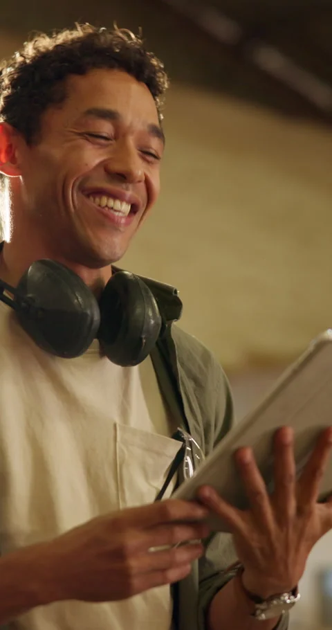 Man, carpenter and laugh in workshop with tablet, research and funny feedback Stock Footage 341422456