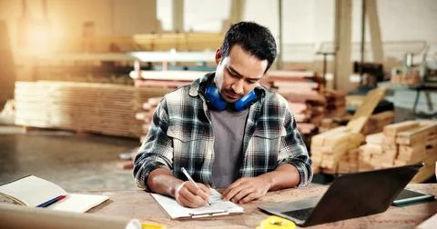 Man, carpenter and writing at workshop with clipboard, stock and pricing timber Stock Photos
