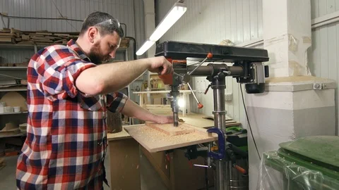 Man carpenter in a shirt using drilling machine in slowmotion Stock Footage 88830709