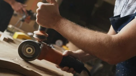 A man carpenter is working with wood using circular saw machine Stock Footage 89306769