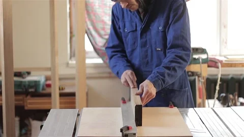 Man carpenter in workshop working with hardwood wearing blue uniform indoors  스톡 동영상 88125977