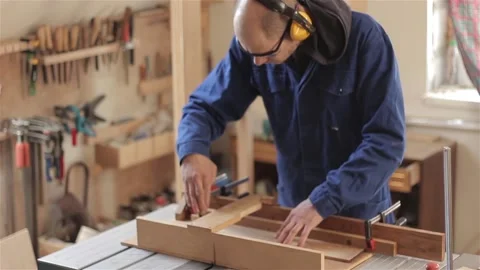Man carpenter in workshop working with hardwood wearing blue uniform indoors  스톡 동영상 88186584