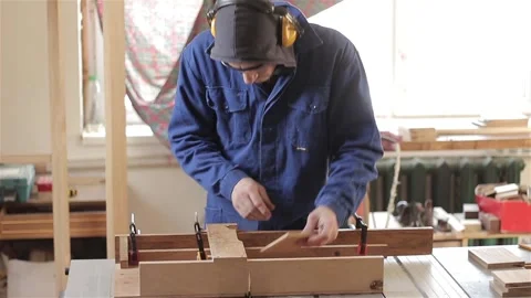 Man carpenter in workshop working with hardwood wearing blue uniform indoors  스톡 동영상 88270281