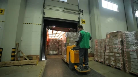 Man carries a cargo in a warehouse Video stock 64017710
