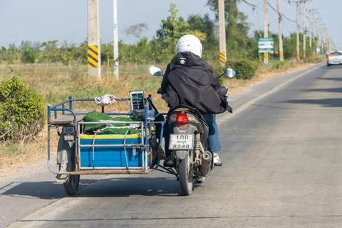A man carries a load on a sidecar Stock Photos