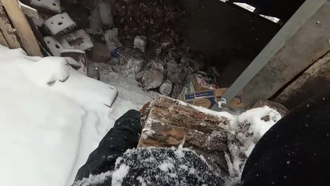 Man carries a log and throws it in the winter Stock Footage 85135775