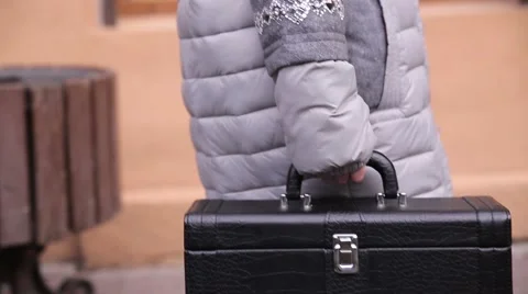 Man carries small suitcase Stock Footage 60117684