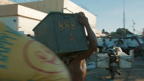 Man Carrying a Box in a Third World Country Stock Footage 128656099