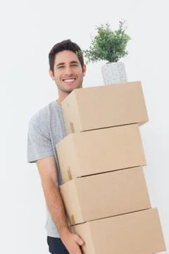 Man carrying boxes because he is moving Photos