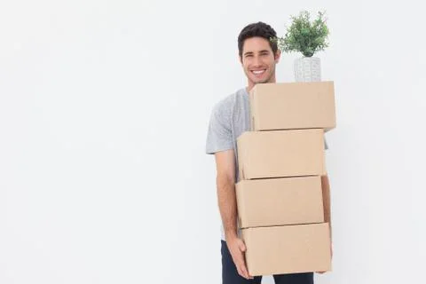 Man carrying boxes because he is moving in a new house Photos