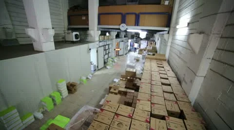 Man carrying boxes in storage room Stock Footage 23344574