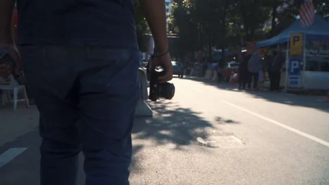 A man carrying compact camera at Kuala Lumpur downtown Video stock 142007592