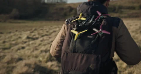 A man carrying a drone in his backpack and going on a hiking trip ـ Video 動画素材 271028362