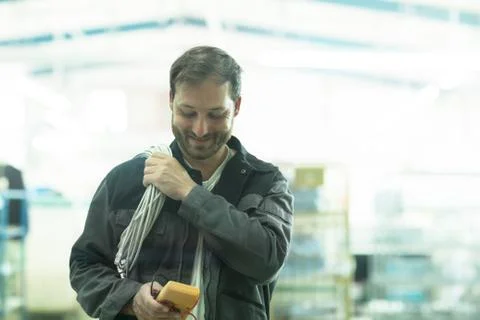 Man carrying electrical cable and test meter Stock Photos