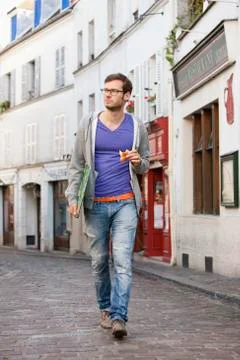 Man carrying a file while eating food, Paris, Ile-de-France, France Stock Photos