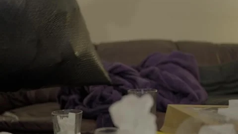 Man Carrying Garbage Bag Past Messy Table Cleanup, Living Room Scene Stock Footage 323877941
