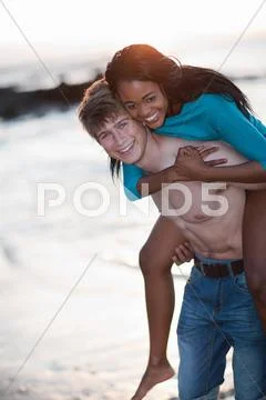 Man Carrying Girlfriend On Beach