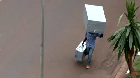 Man carrying heavy stuffs alone in the street Stock Footage 47850109