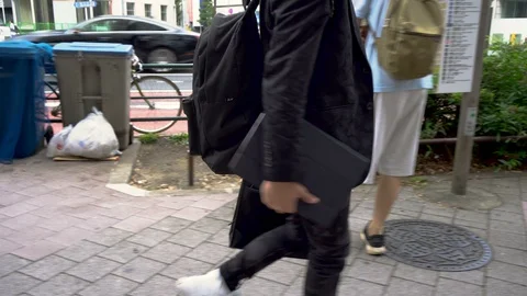 Man Carrying Large Tablet in Hand - Side View Tracking Shot Stock Footage 104476399