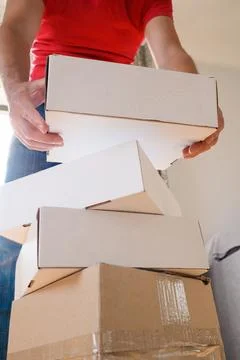 Man Carrying Stack of Moving Boxes Stock Photos