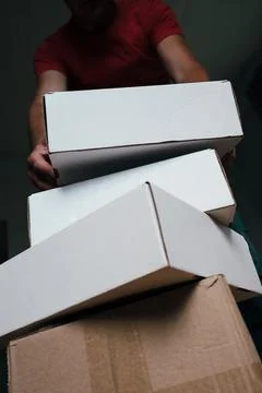 Man Carrying Stack of Moving Boxes Stock Photos
