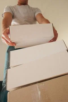 Man Carrying Stack of Moving Boxes Stock Photos