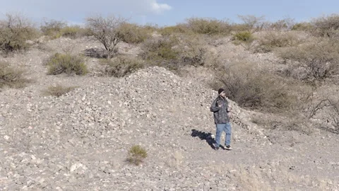 Man carrying a thermos and drinking mate in the Calchaquí Valleys of Argentina Stock Footage 338389382