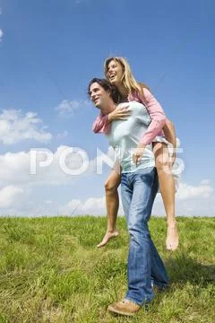 Man Carrying Woman Piggyback