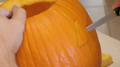 Man Carves a Face in a Pumpkin Stock Footage 68762789