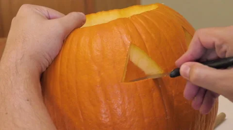 Man Carves a Jack 'o' Lantern Stock Footage 68759423