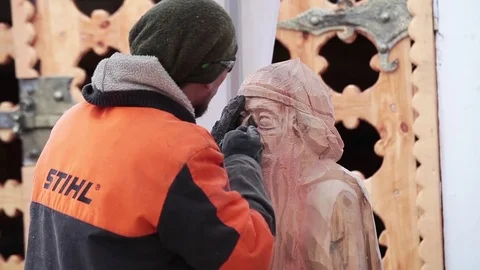 Man carving figure from wood using Stihl instrument Stock Footage 72287650