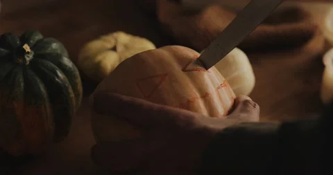  Man carving a jack o' lantern in a moody light Stock Footage 140823239