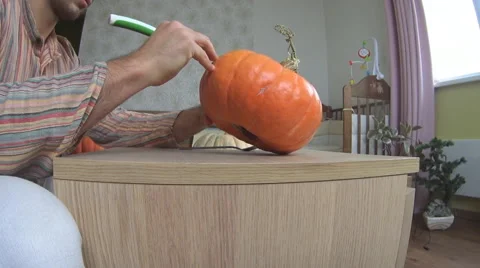 Man carving pumpkin for Helloween Stock Footage 68627331