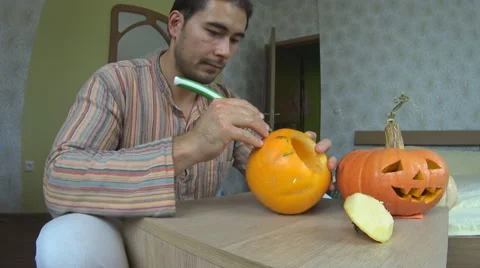 Man carving pumpkin for Helloween Stock Footage 68659473