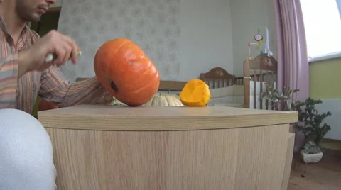Man carving pumpkin for Helloween Stock Footage 68685078