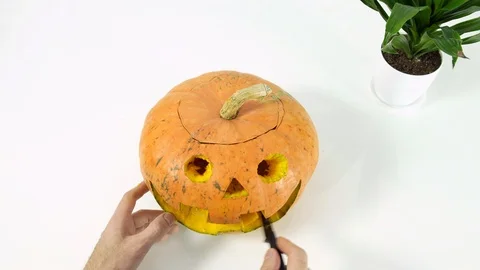 Man carving pumpkin for Helloween Stock Footage 102785931
