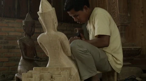 Man carving stone Buddha statue in Cambodia Stock Footage 48035964